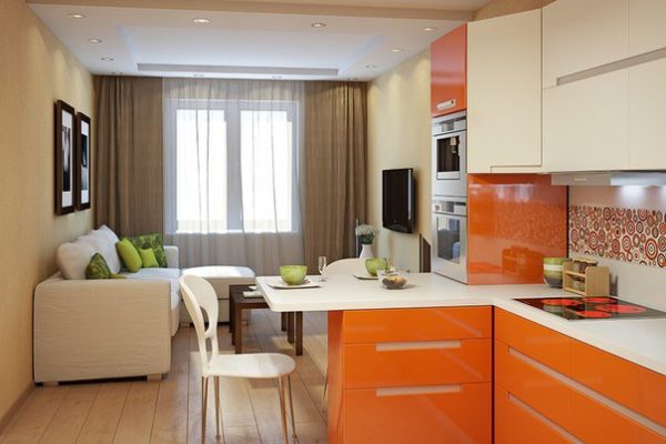 Оранжевый кухонный гарнитур и белый диван 